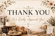 A bakery-themed 'Thank You' sign with floral corner decorations, a rolling pin, and baked goods including a cake, cupcakes, muffins, and breads arranged on a table. The sign reads 'THANK YOU We Really Appreciate You!' in large black and brown lettering.