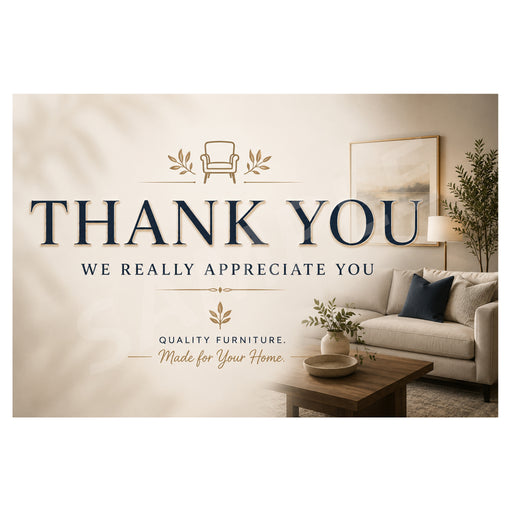 A large beige and navy 'THANK YOU' sign with decorative furniture illustrations, placed over a staged living room scene showing a sofa, coffee table, lamp, and framed wall art.