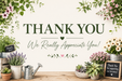 A decorative thank-you graphic with the words 'THANK YOU We Really Appreciate You!' centered on a cream background, surrounded by floral arrangements, potted plants, a watering can, and small chalkboard signs on a wooden surface.