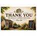 A rustic-themed thank you sign with a warm beige background, featuring a small wooden shed illustration at the top, the words 'THANK YOU WE REALLY APPRECIATE YOU' in large dark brown lettering, and a small chalkboard sign reading 'Premium Quality Sheds' in the lower right. The bottom portion shows a scenic illustration of a garden path leading to another shed surrounded by greenery and flowers.