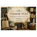 A rustic vintage-style doormat or sign featuring the text 'THANK YOU WE REALLY APPRECIATE YOU' and 'THRIFT SHOP' in the center, surrounded by a cozy antique shop scene with a teddy bear, basket, books, and signs.